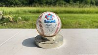 Front view showing Blue Jays logo and autographs on baseball atop metal base