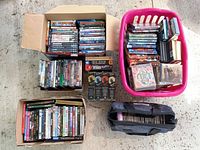 Multiple containers of DVDs and CDs showing quantity and variety