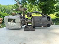 Full side view of pump showing motor, housing and valve