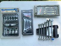 All four packaged wrench sets displayed on table