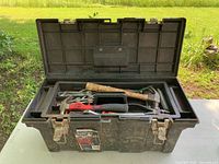 Front view of open toolbox showing exterior condition and tray with tools