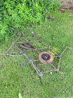 overall view of rusted steel drag harrow on grass