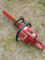 Full view of chainsaw showing bar, handles and body