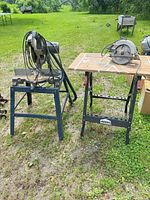 Wide view of chop saw on blue stand and Jobmate workbench with circular saw