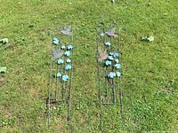 Full view of both metal trellises laid on grass