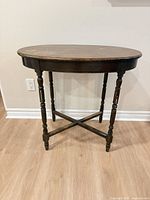 Full view of table front showing turned legs and X stretcher