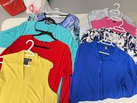Eight tops laid out showing colours and styles