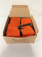 Box opened showing orange straps neatly folded