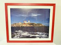 Front view of framed lighthouse print in red wood frame