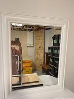 Front view of white framed rectangular mirror