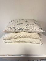 Three stacked Scandown pillows showing patterned top and plain lower pillows