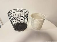 Ceramic planter and metal basket side by side