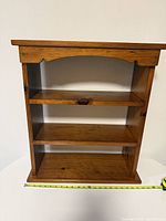 front view showing three shelves and scalloped top