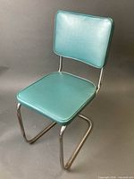 Full view of chrome and turquoise vinyl chair