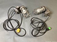 Both cage style work lights with cords and plugs visible