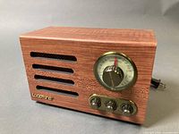 Front view showing cabinet, tuning dial, knobs, brand logo