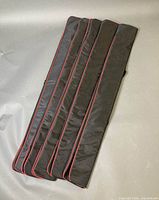 Five folded long soft cases stacked