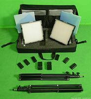 Entire kit laid out: panels, stands, batteries, chargers, case