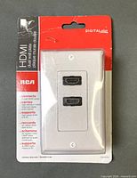 Front of sealed RCA dual HDMI wall plate packaging showing product and branding