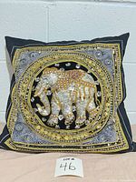 Front view showing embroidered beaded elephant design and overall condition
