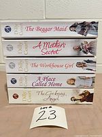 Front view of book spines showing all five titles and author