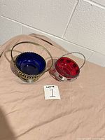Both glass bowls seated in their metal baskets