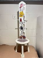 Front view of firefighter themed wood hat rack stool