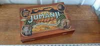 Closed wooden Jumanji box front view with ruler for scale