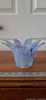 Overall view of ruffled blue-white swirl glass vase