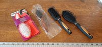 All four brushes and comb laid out with measuring scale