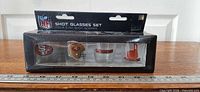 Retail box front showing four shot glasses and NFL branding