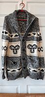 Full front view of cardigan on hanger