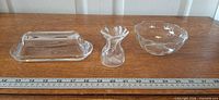 Full view of all three clear glass items on table with ruler for scale