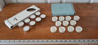 Full lot showing both boxes and all tealight candles with ruler for scale