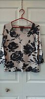 Full view of INC International Concepts beige sweater with black floral print