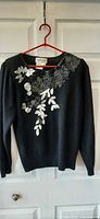 Full front view of sweater showing beaded design
