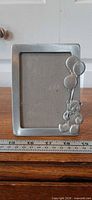 Front view of pewter frame with teddy bear and balloons detail