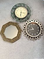 Three wall pieces: two clocks and one mirror