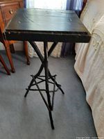 Full view of plant stand showing square top and branch leg structure