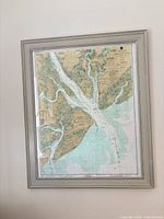 Full view of framed NOAA chart on wall, showing map and frame