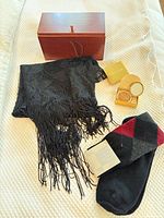 Group shot showing all four items: scarf, socks, wood box, Estée Lauder compact