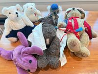 Group shot of six plush toys on table