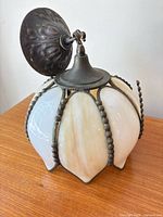 Melon-shaped stained glass pendant showing glass panels and canopy
