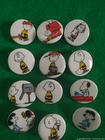 Front view of all 12 buttons showing Peanuts character designs