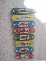 Front view of all eight colourful lithographed bars showing characters and numbers
