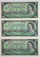 Front view of three 1967 Centennial $1 notes showing serial numbers and design