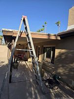 Full view of ladder standing open on patio