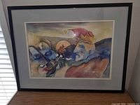 Overall view of framed abstract artwork leaning against wall