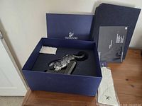 Panther figurine inside original box with foam insert, outer sleeve and paperwork visible