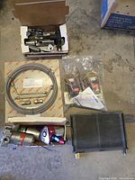 Overview of entire automotive lot showing pumps, hose kit, cooler, solenoids